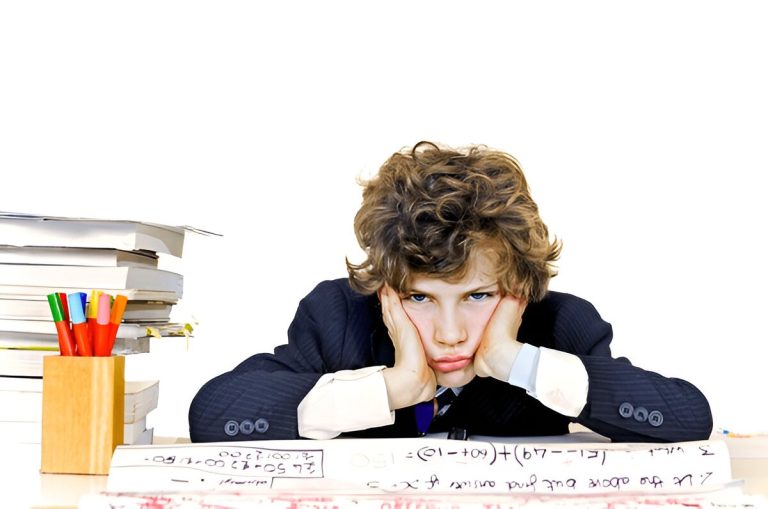 Frustrated student sitting at desk, struggling with math homework, highlighting the need for extra tuition support.